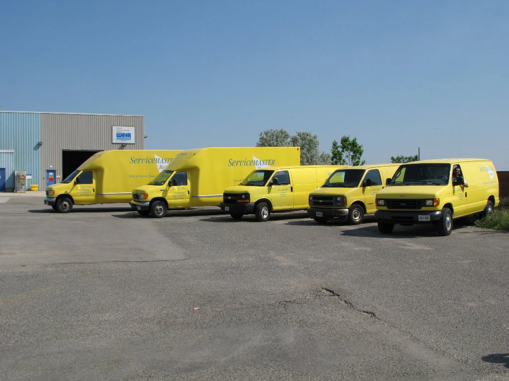 Five-Yellow-ServiceMaster-Trucks-in-Parking-Lot