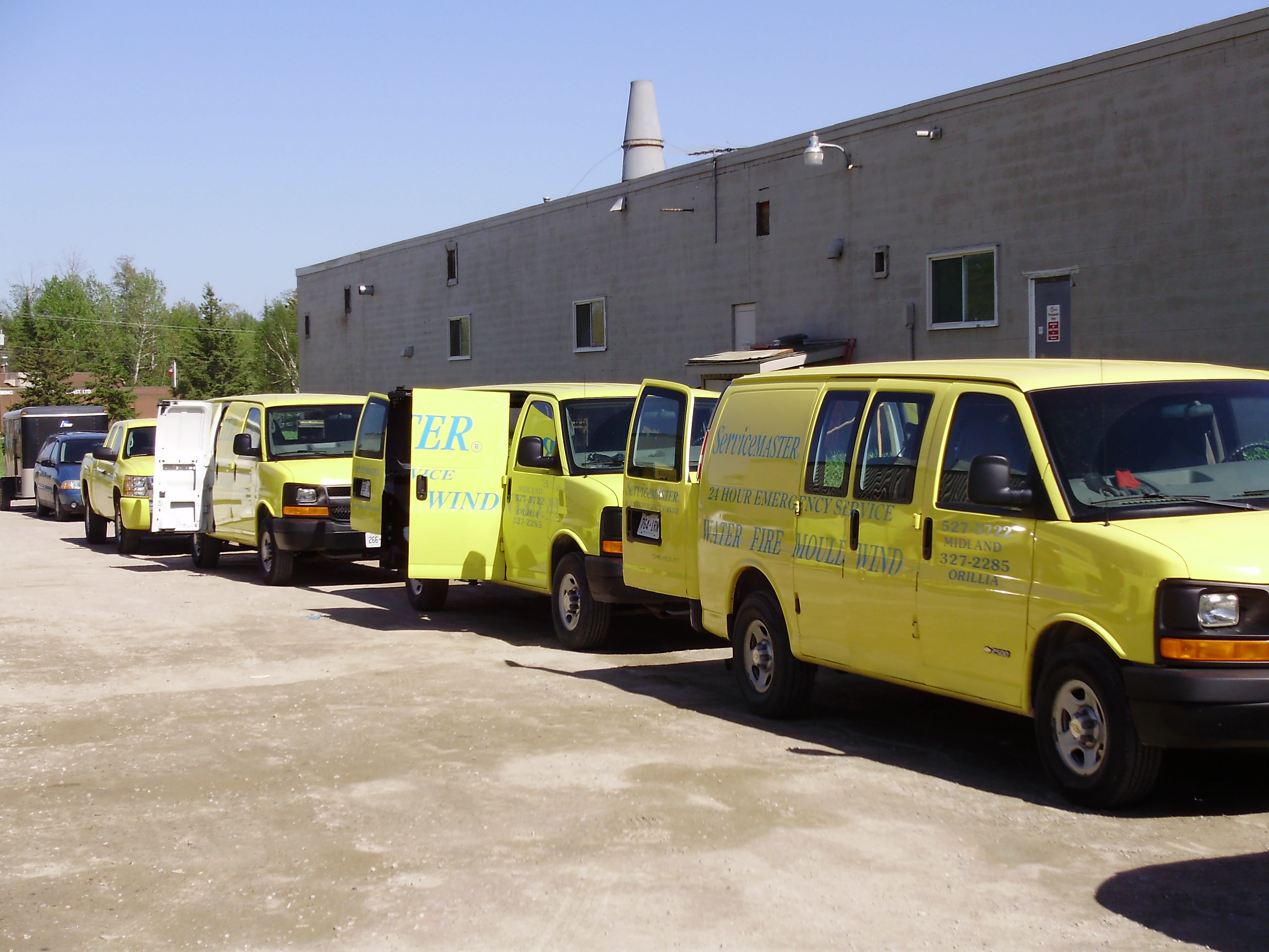 Line-of-four-yellow-ServiceMaster-Vehicles