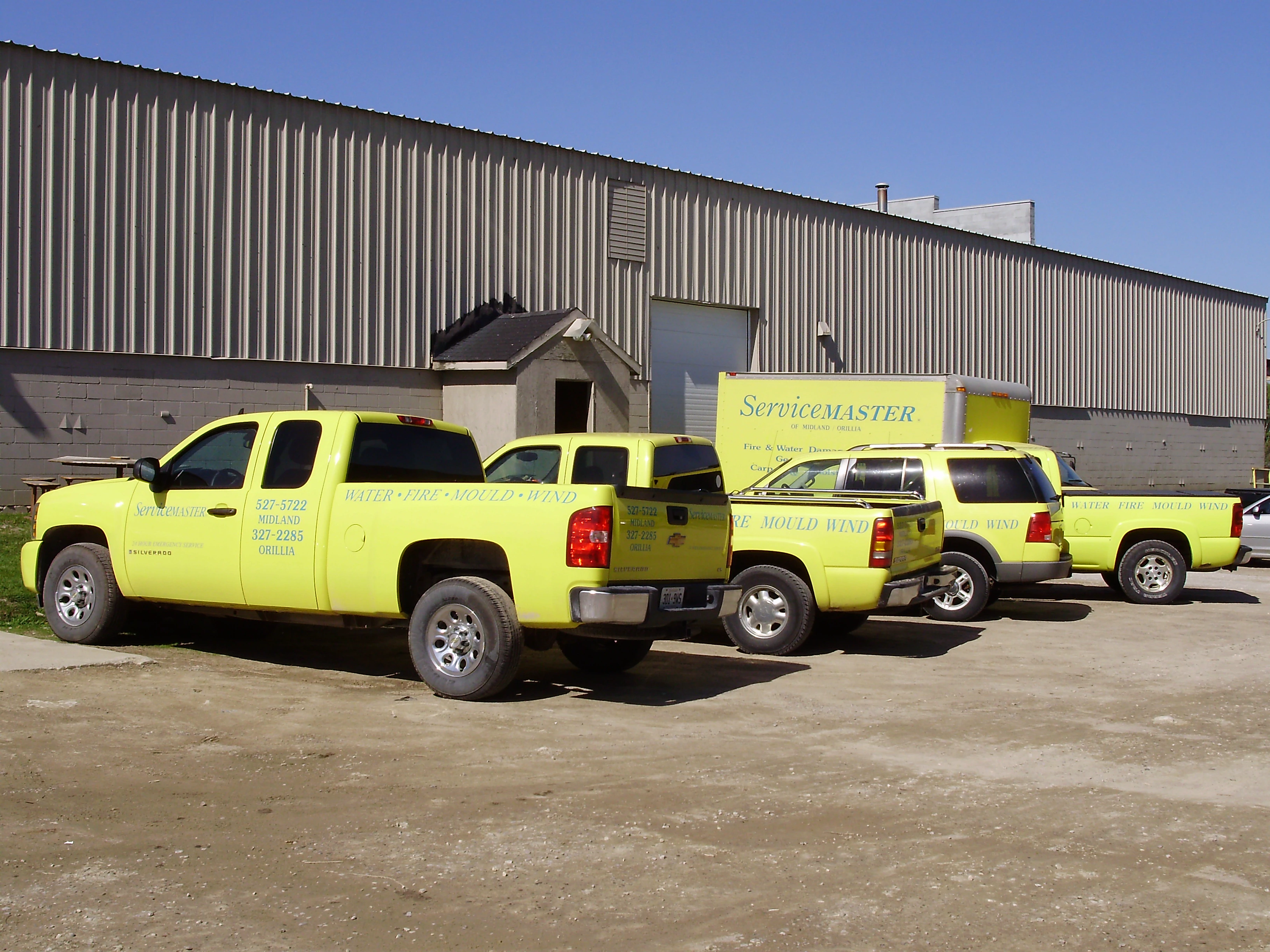 Yellow-ServiceMaster-Vehicles-in-Parking-Lot