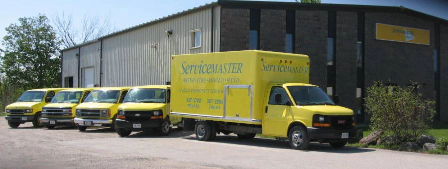 Five-Yellow-ServiceMaster-Vehicles-by-ServiceMaster-Building