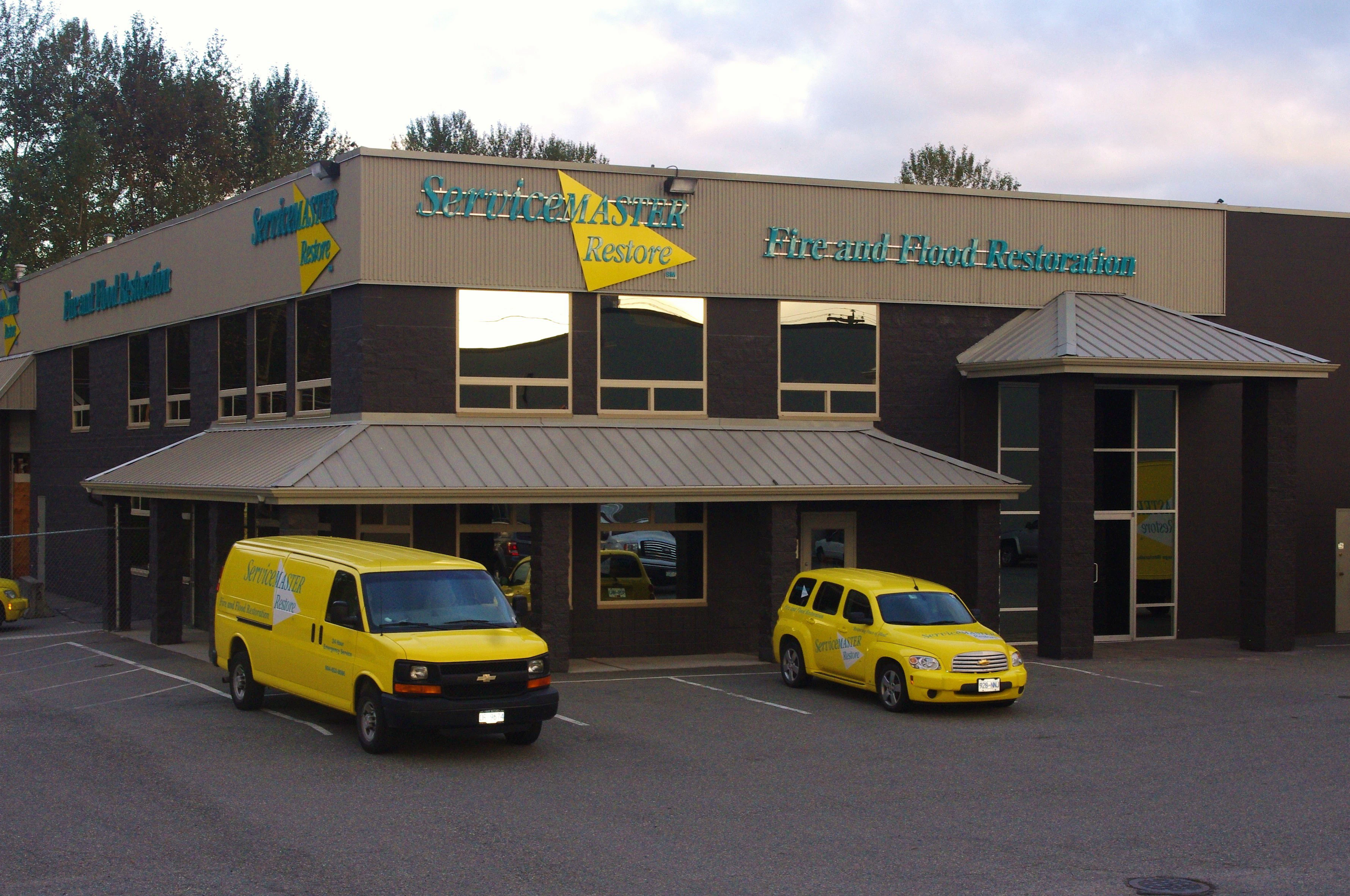 ServiceMaster-Building-and-two-yellow-ServiceMaster-vehicles