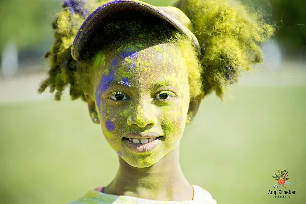 Child-covered-in-colourful-powder-at-humanitarian-event