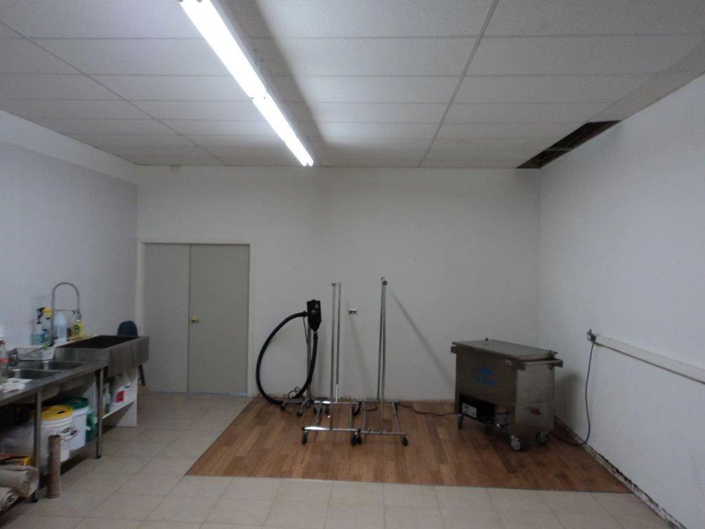 Cleaning-Area-with-sink,-cleaning-tools,-and-drying-racks