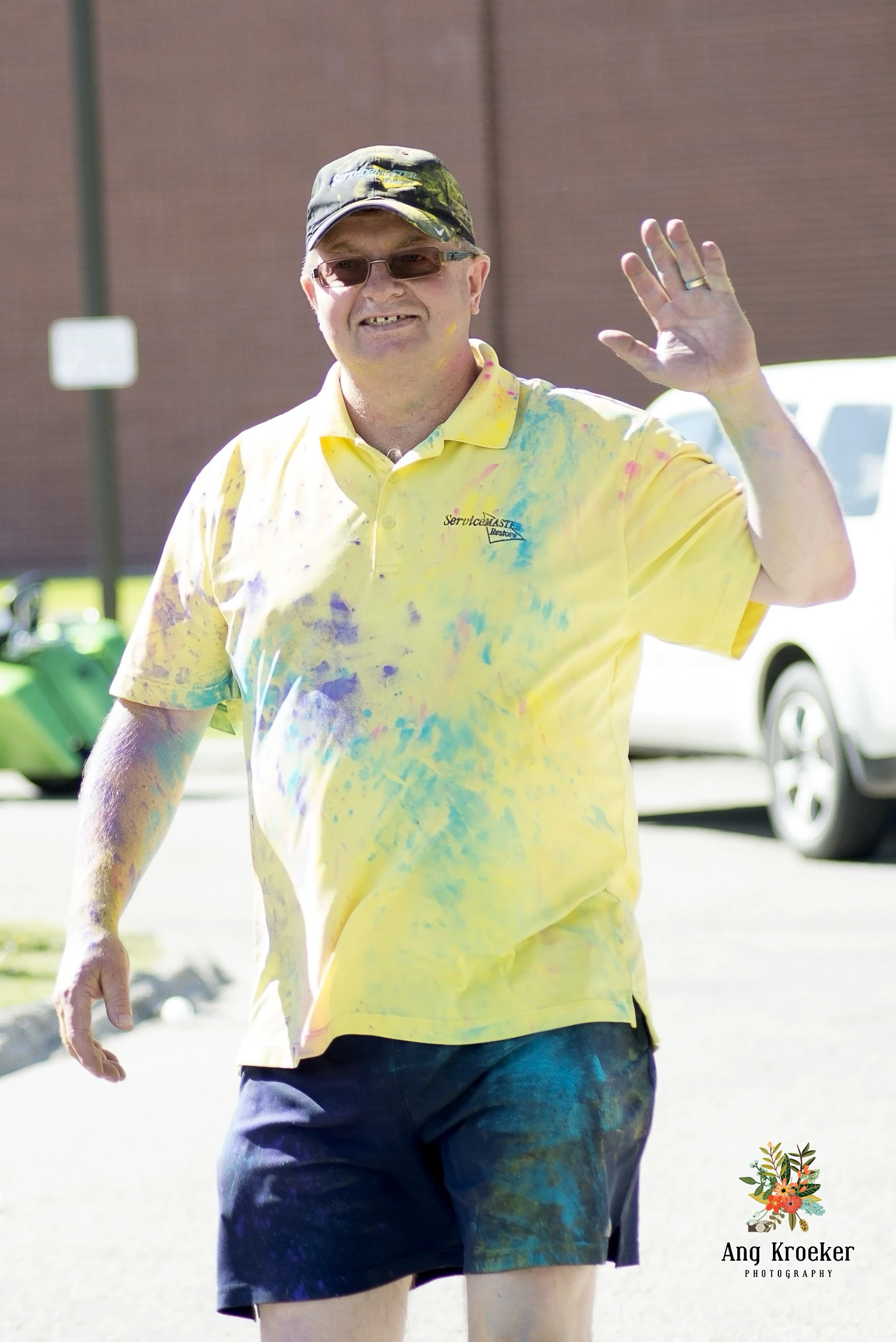 Man-full-of-colourful-powder-at-community-event
