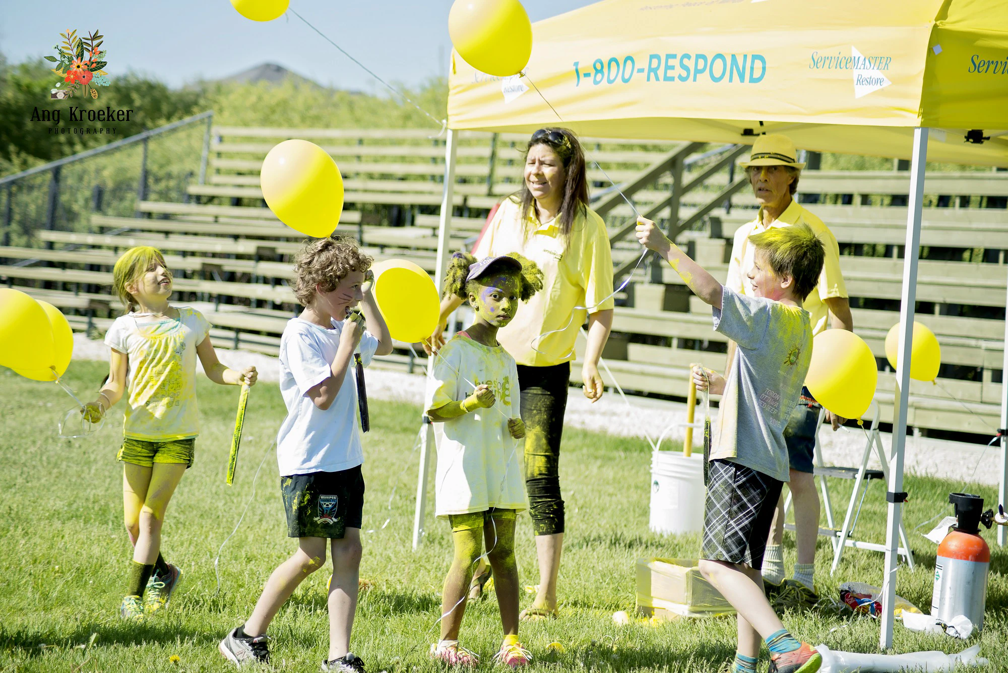 ServiceMaster-tent-at-Canadian-Humanitarian-and-children-holding-yellow-balloons