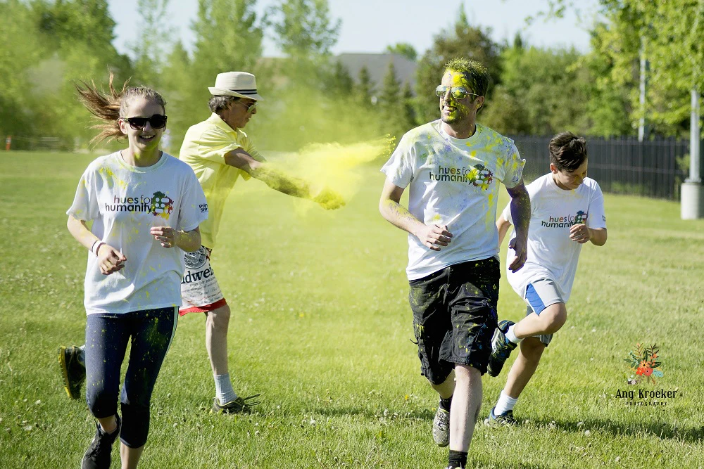 Individuals-running-with-yellow-colour-powder-being-thrown